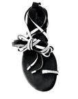 Black sandal with decorative straps on a white background