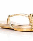 Gold sandal with rope design on a white background